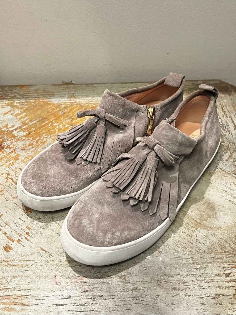 Kate Spade Taupe Gray Suede Fringed Tassel Slip-On Sneakers Gold Tone Side Zip